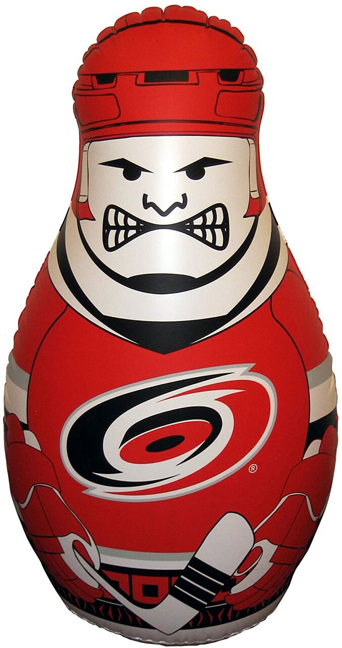 Inflatable vinyl punching bag shaped like a Carolina Hurricanes NHL player with red primary jersey and a grumpy face.