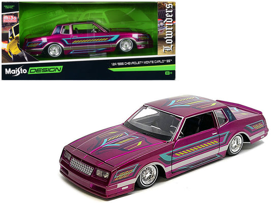 Maisto 1/24 scale 1986 Chevrolet Monte Carlo SS Lowrider in pink metallic with graphics – diecast collectible model