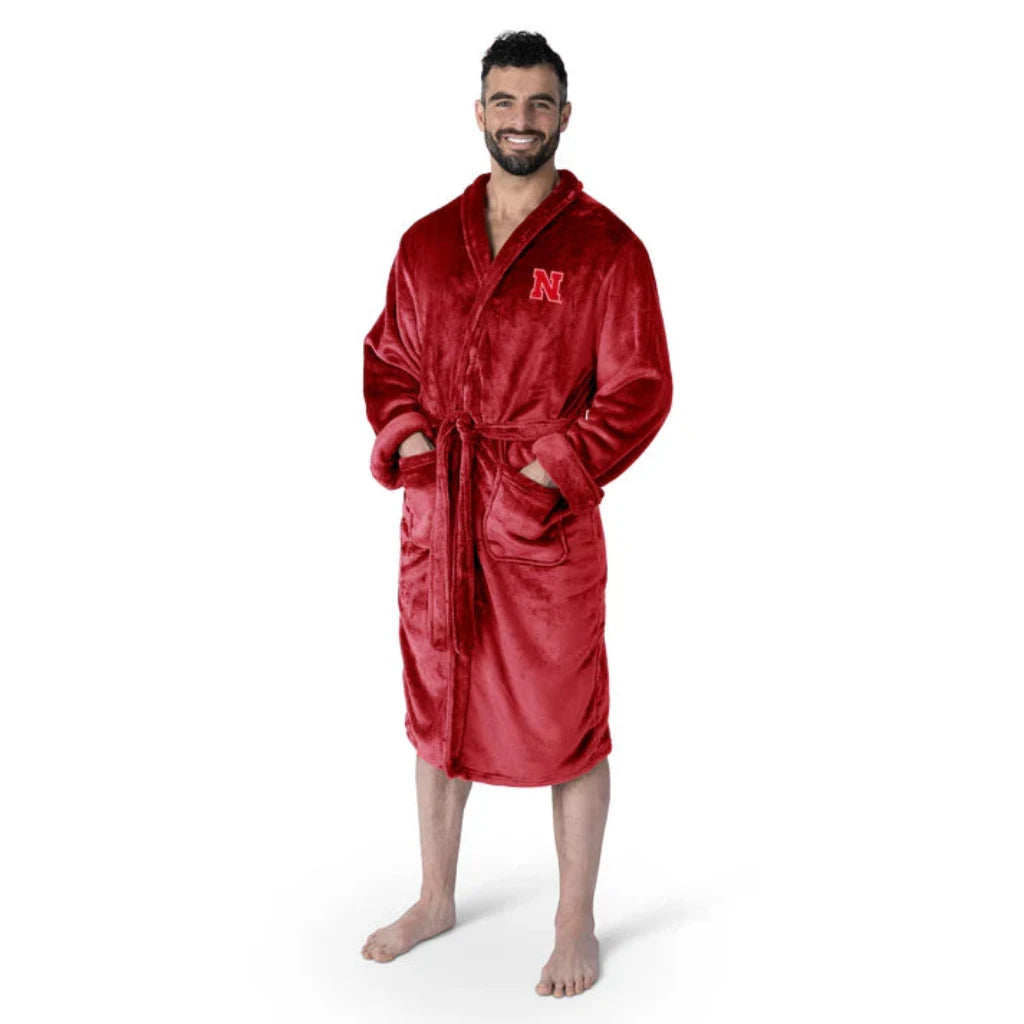 Nebraska Cornhuskers bathrobe with silky-soft fabric, embroidered logo, tie belt, and pockets. Officially licensed NCAA product.