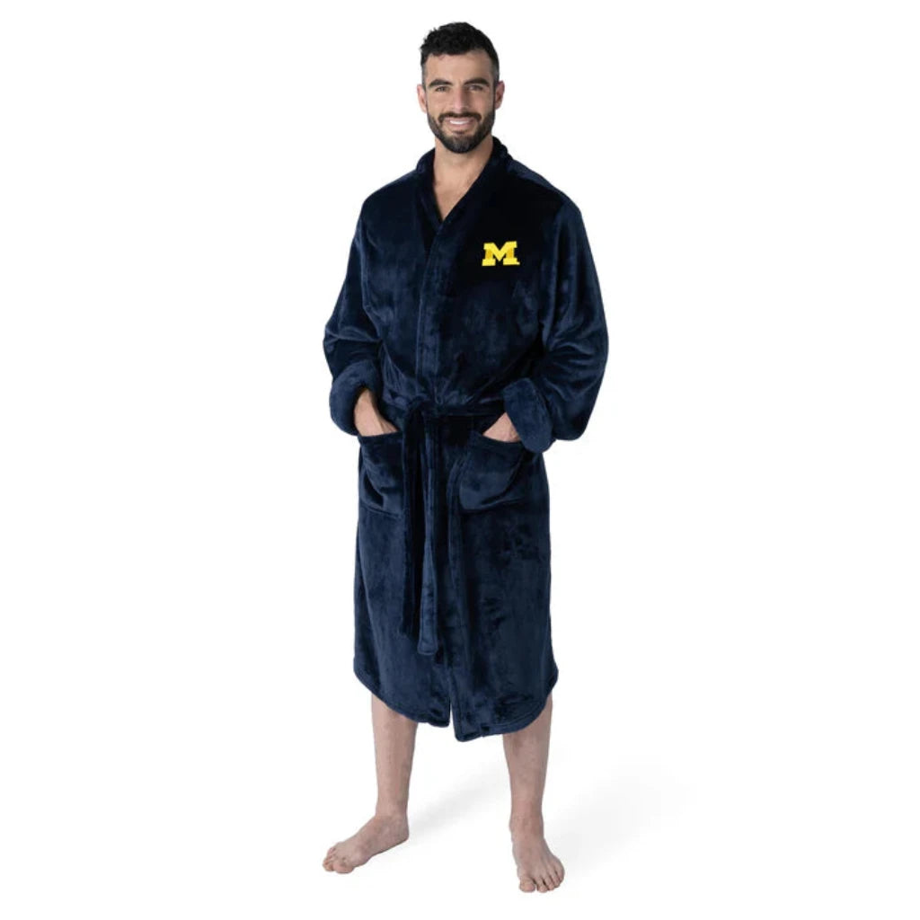 Michigan Wolverines bathrobe with silky-soft fabric, embroidered logo, tie belt, and pockets. Officially licensed NCAA product.