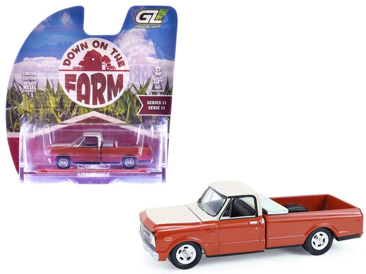 Greenlight 1968 Chevrolet C-10 pickup diecast model with toolbox in orange and beige 1/64 scale display case