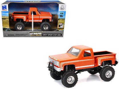New Ray 1/30 Chevrolet Sport Step Side Pickup Truck diecast in orange with white graphics and off-road suspension.