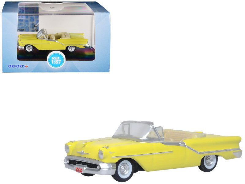 1957 Oldsmobile 88 Convertible in Coronado Yellow, 1/87 scale diecast model car displayed in a plastic showcase.