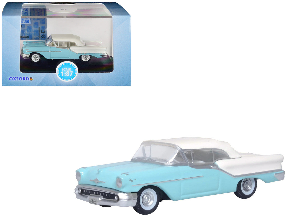 1957 Oldsmobile 88 Convertible in Banff Blue and Alcan White, 1/87 scale diecast model car in display showcase.