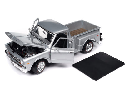 Model of a silver pickup truck with open hood 