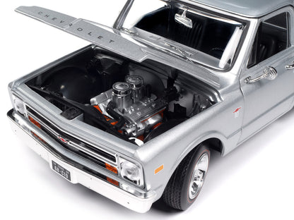 Model of a Chevrolet truck with open hood showing engine details 