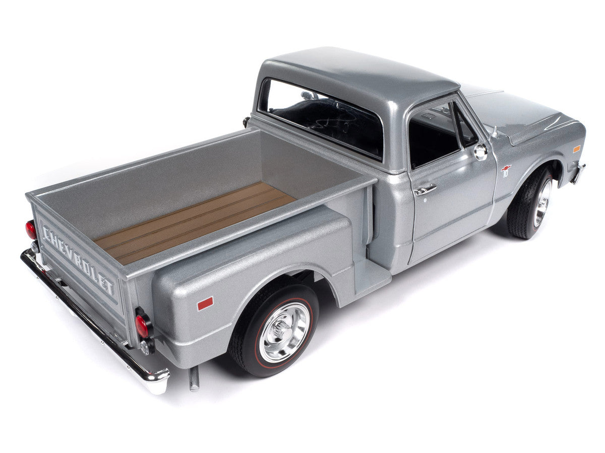 Model of a silver Chevrolet truck on a white background