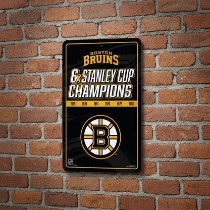 Boston Bruins sign celebrating 6 Stanley Cup championships on a brick wall