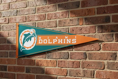 Miami Dolphins 12x30-inch retro NFL felt pennant on a brick wall