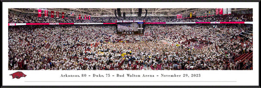 A panoramic photo featuring the Arkansas Razorbacks basketball team with a capacity crowd in attendance at Bud Walton Arena