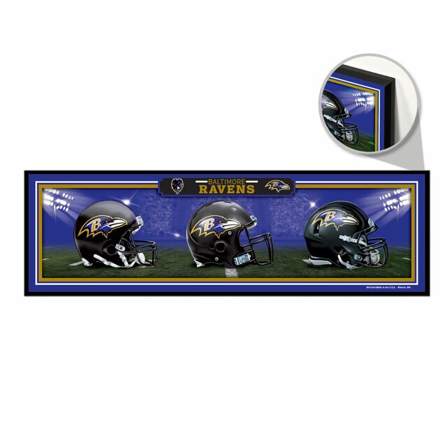 A wooden sign featuring the Baltimore Ravens different throwback helmet designs 