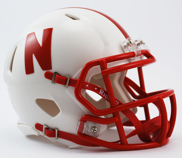 Nebraska Cornhuskers Riddell mini speed helmet with official decals, metal faceguard, chin strap, and foam padding, 5.5 inches tall