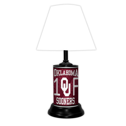 Oklahoma Sooners tabletop lamp featuring team colors, logo and wording "#1 Fan" with black base and white shade